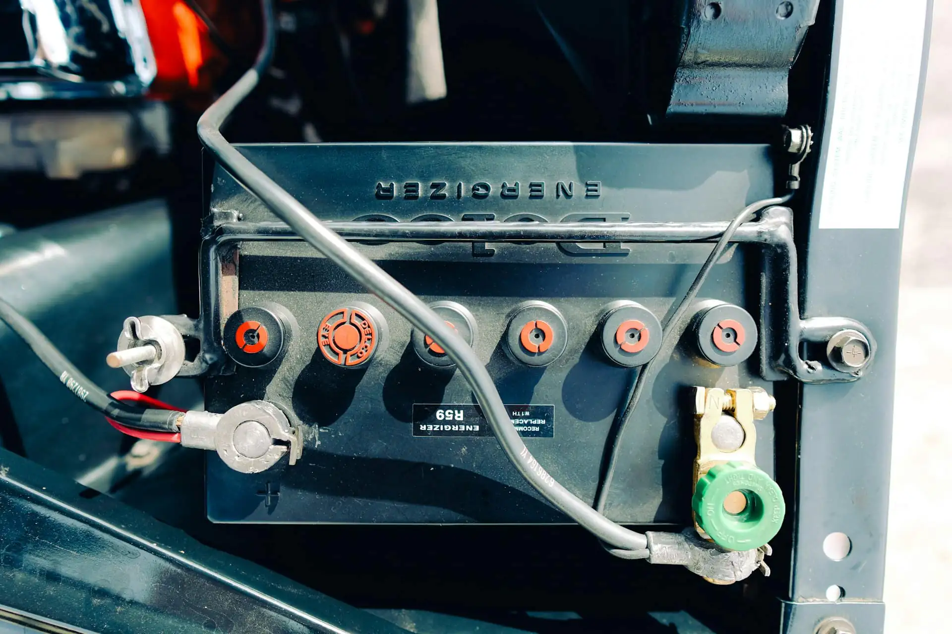 Close-up of a car battery with its terminals and cables connected