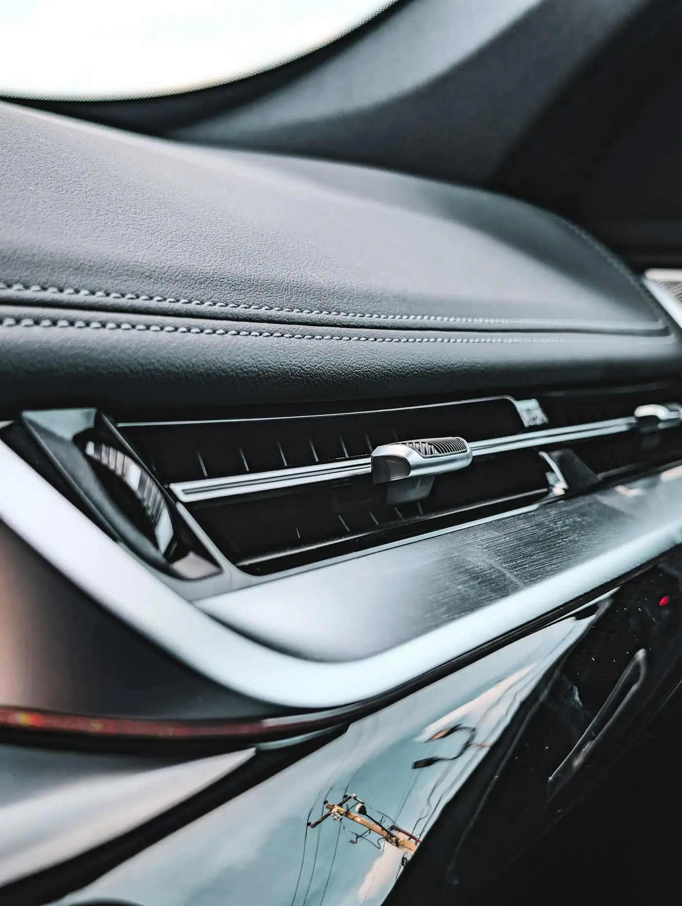 A slim air vent on a modern car dashboard